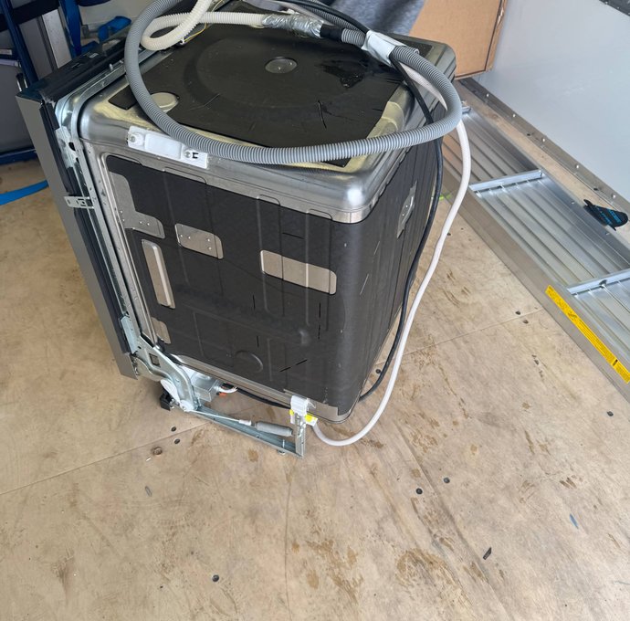 Washing machine wrapped and strapped for appliance installation