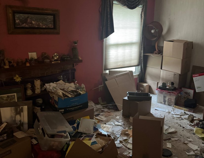Cluttered room awaiting move-out cleanout